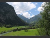 Grön och lummig dalgång i Heiligenblut, Österrike, Alperna. Berget Grossglockner och blå himmel i kulissen.